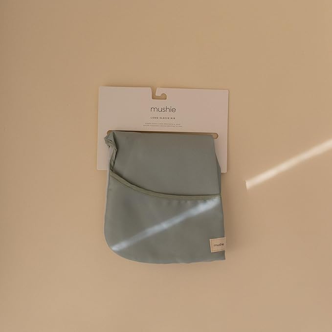 mushie Long Sleeve Baby Bib | Water Resistant Adjustable Fit for Ages 6-24 Months