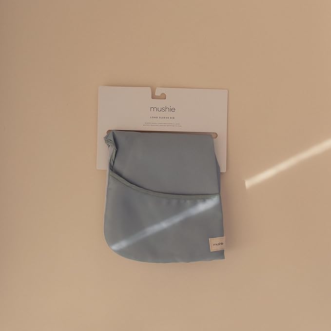 mushie Long Sleeve Baby Bib | Water Resistant Adjustable Fit for Ages 6-24 Months